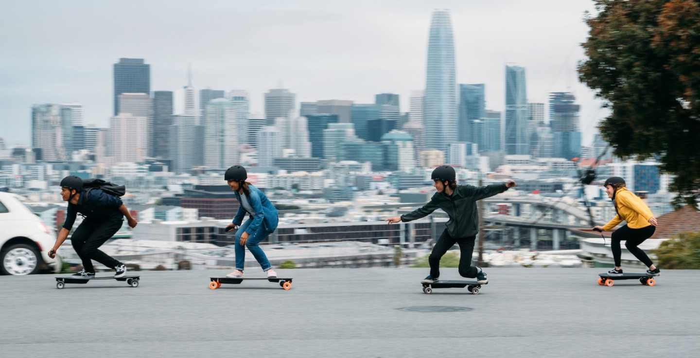 boys and girls rideing electric sketboard on road