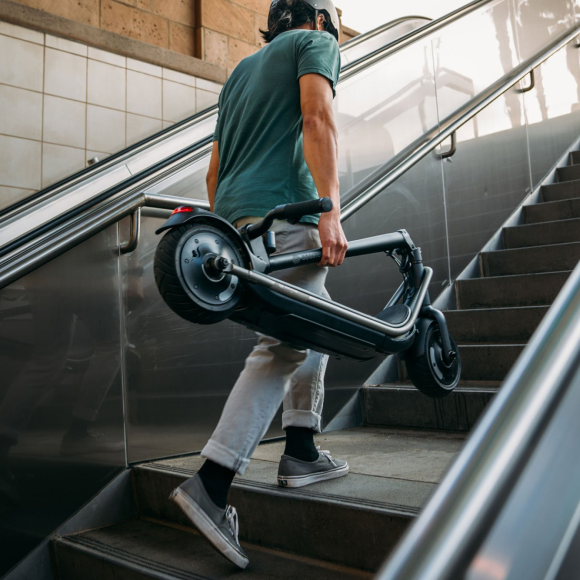 a man going upstair with holding a electric rev