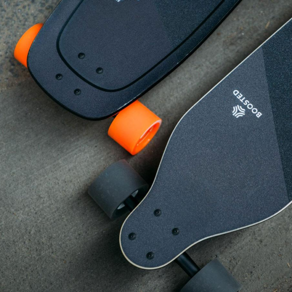 black sketboard with orange or black wheel